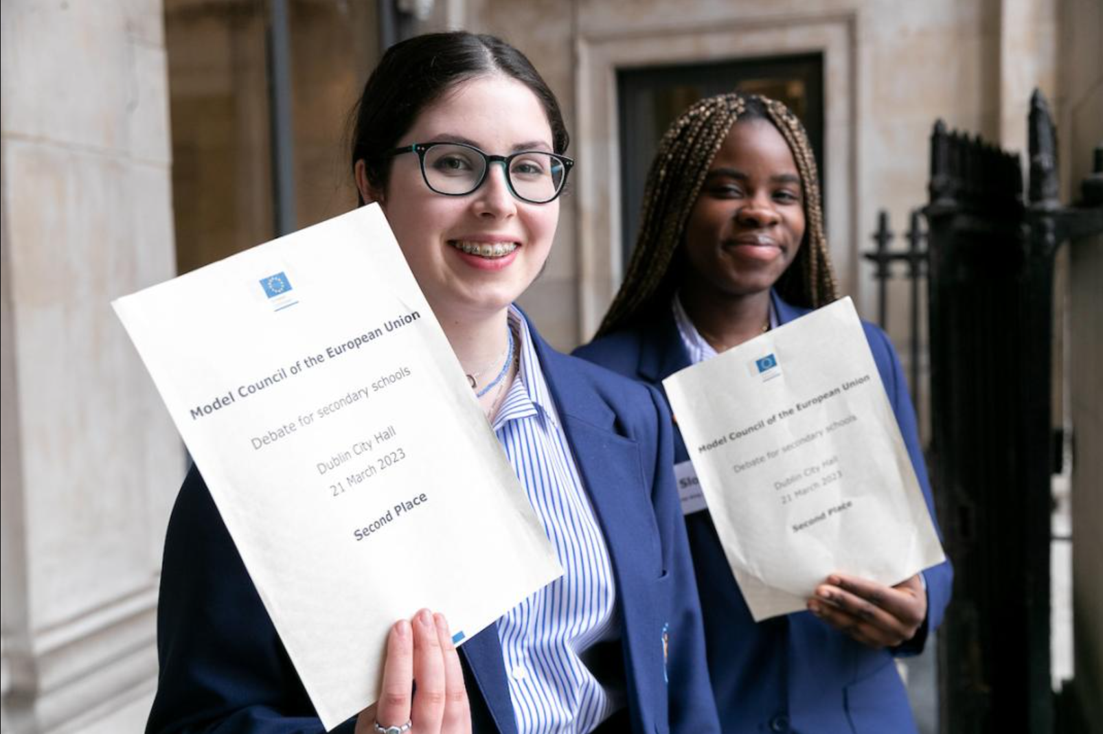 Two students holding second-place certificates from the Model Council of the European Union debate.