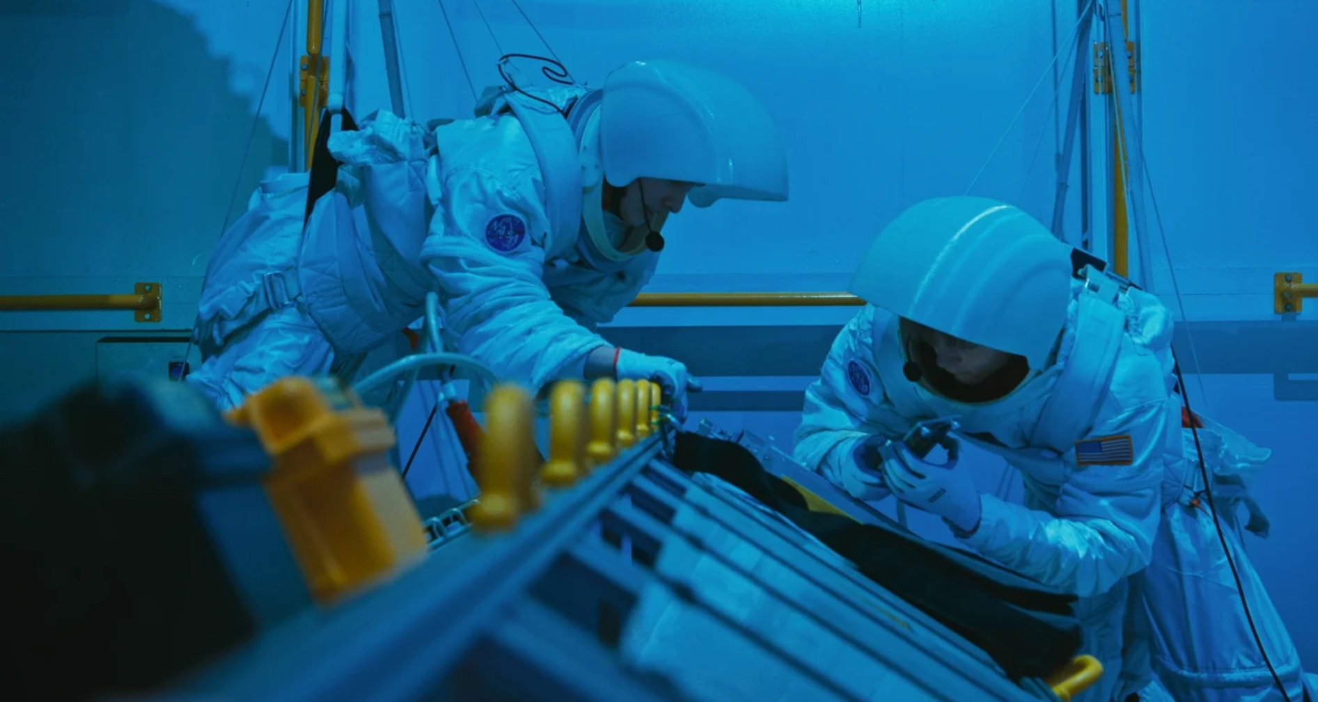 Space Camp Challenge contestants in spacesuits during an underwater training exercise.